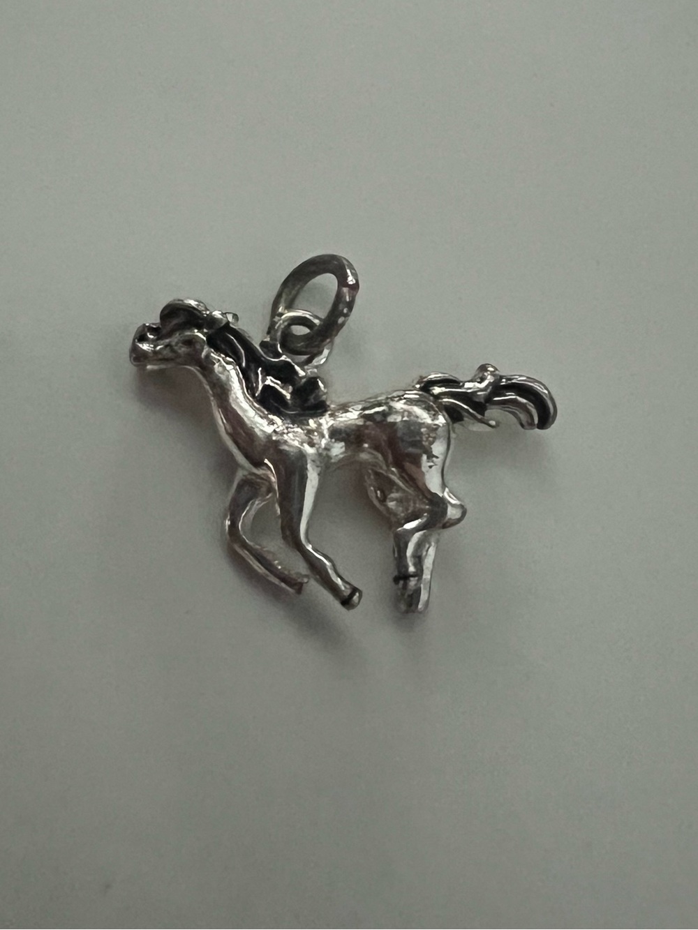 Silver toned horse charm pendant